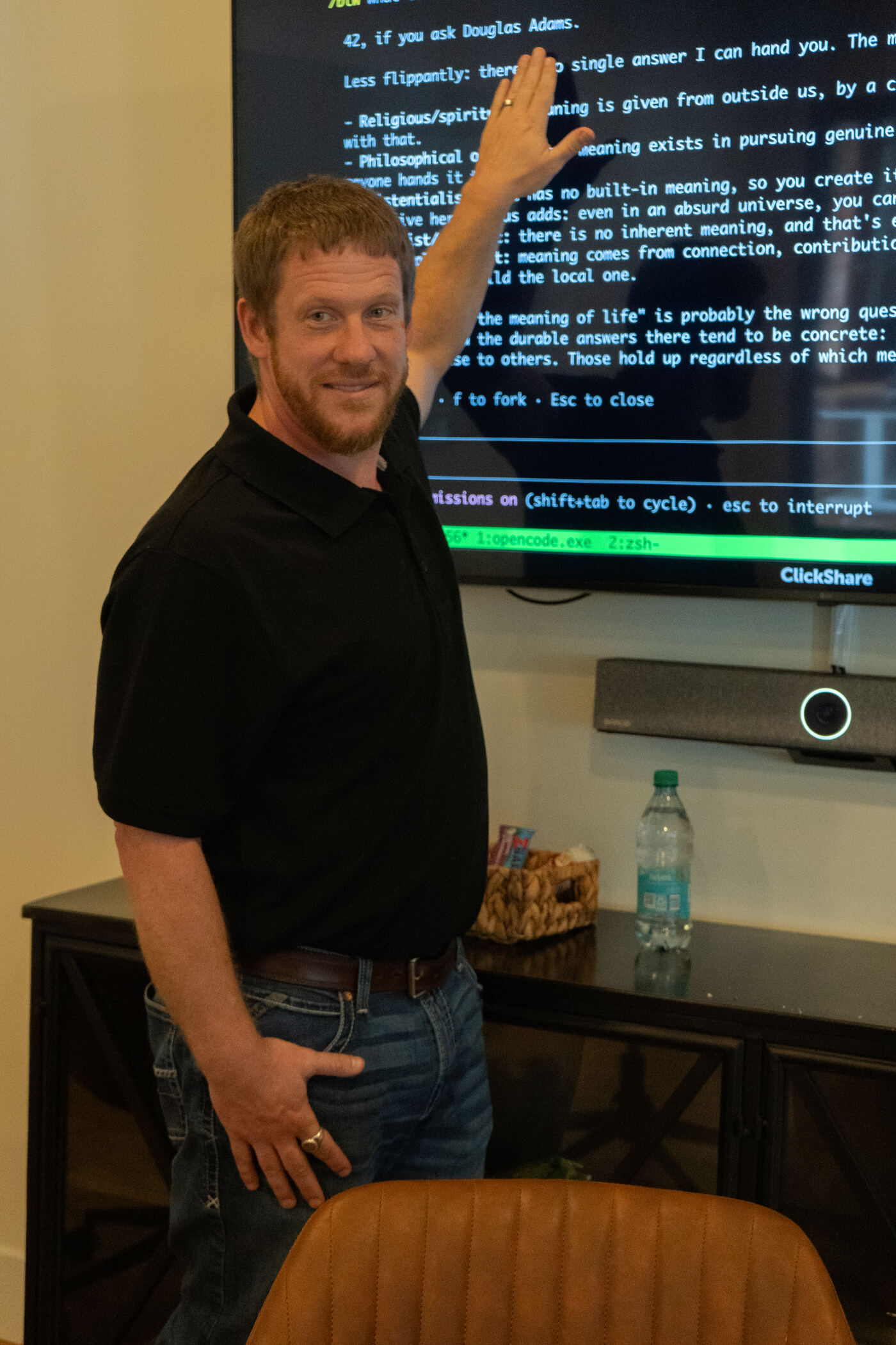 Wes lecturing with code examples projected behind him